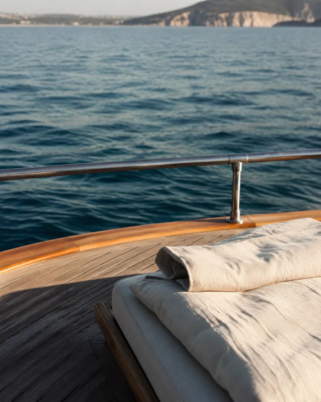 Teak, linen and open water on a quiet morning at sea